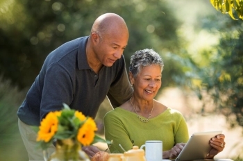 Couple reviewing information on tablet